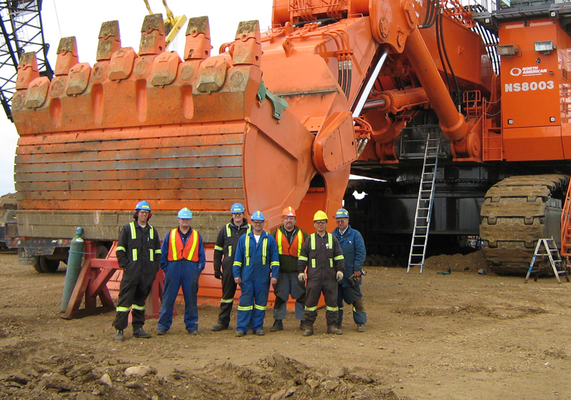 group of miners standing in front of an 8000 shovel