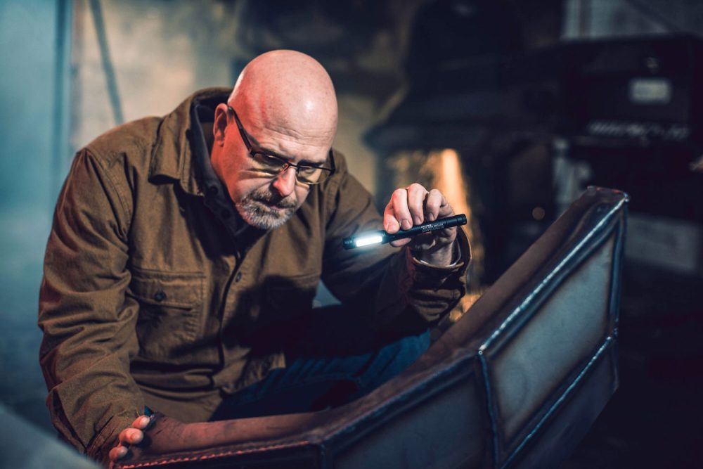 man holding pen flashlight