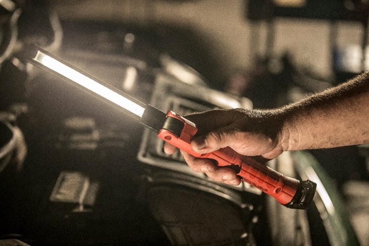 stringer switchblade being used to illuminate car engine