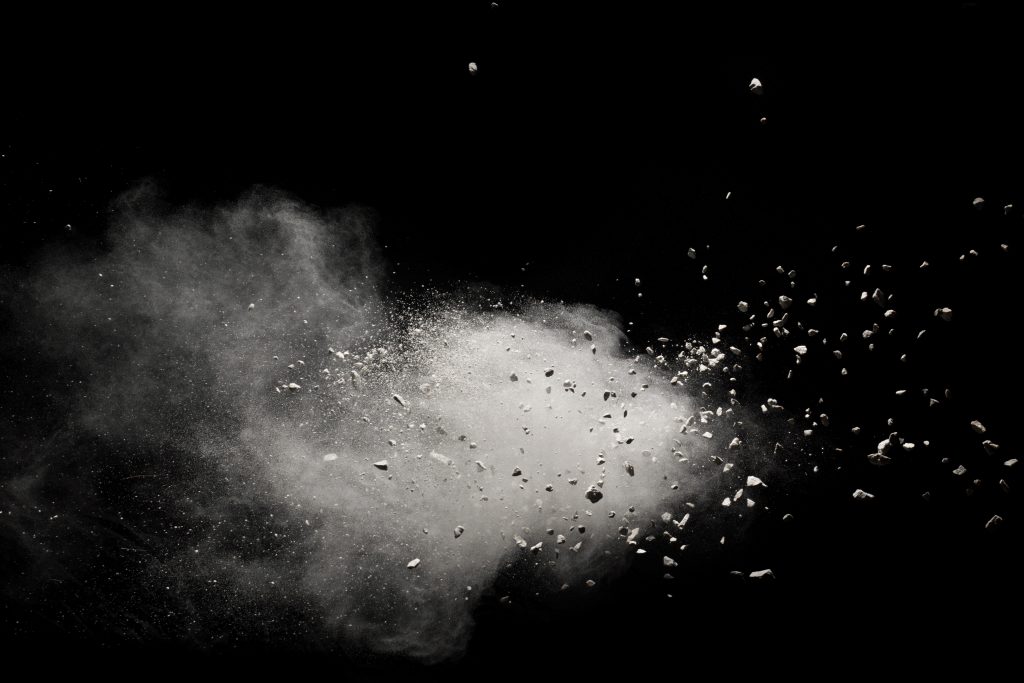 Small granite rock stone fly isolated on black background.