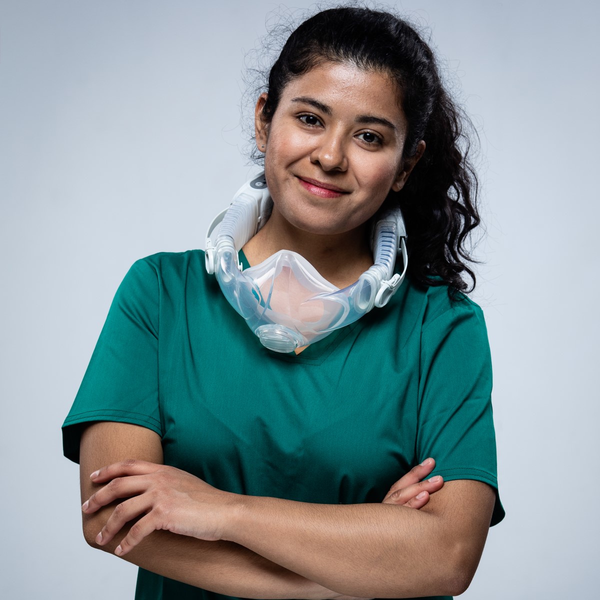 Healthcare professional wearing cleanspace halo with folded arms smiling at camera