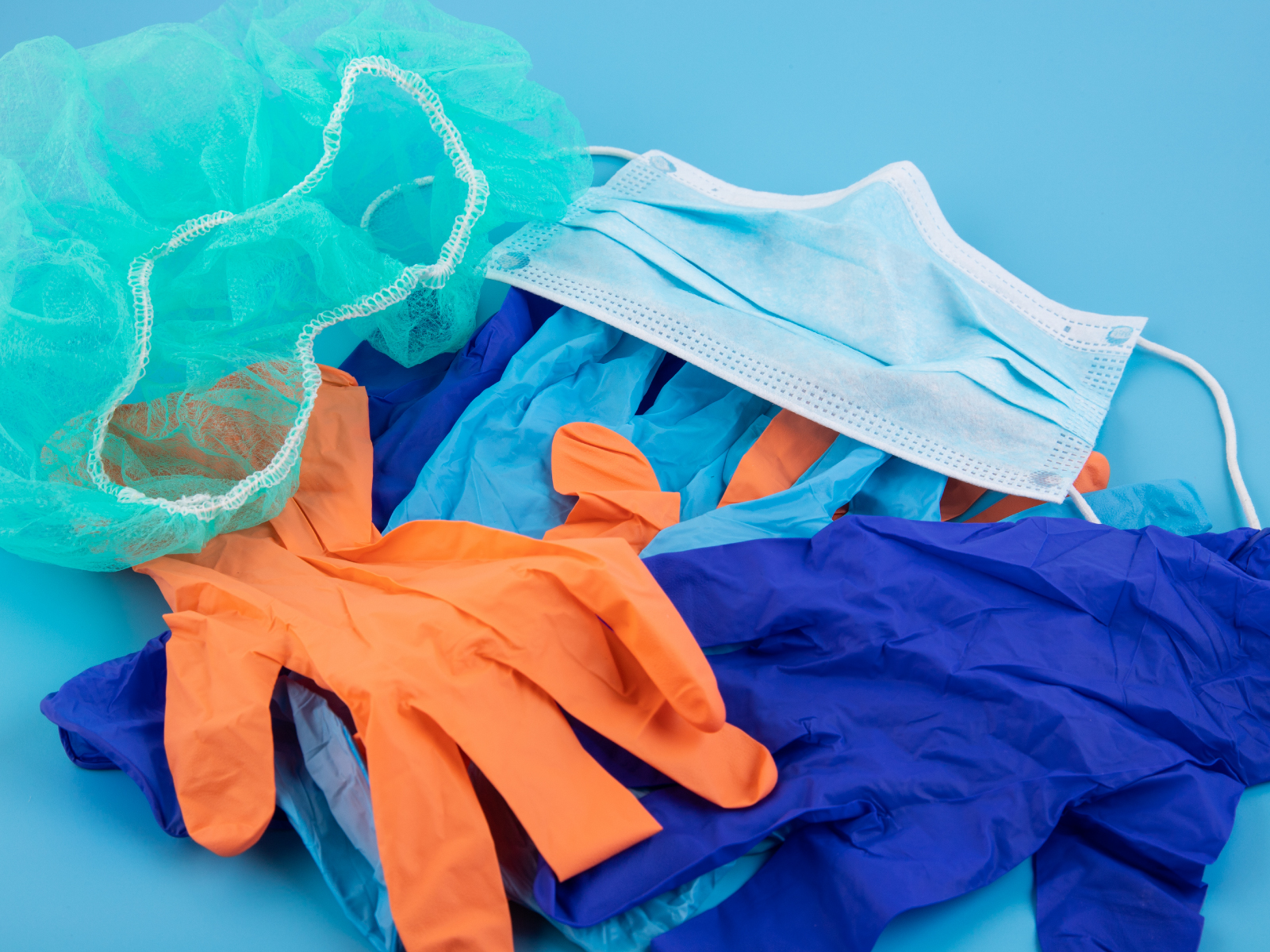 a used pile of disposable masks and gloves