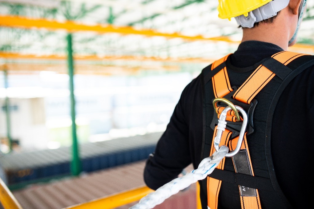 man wearing fall protection harness