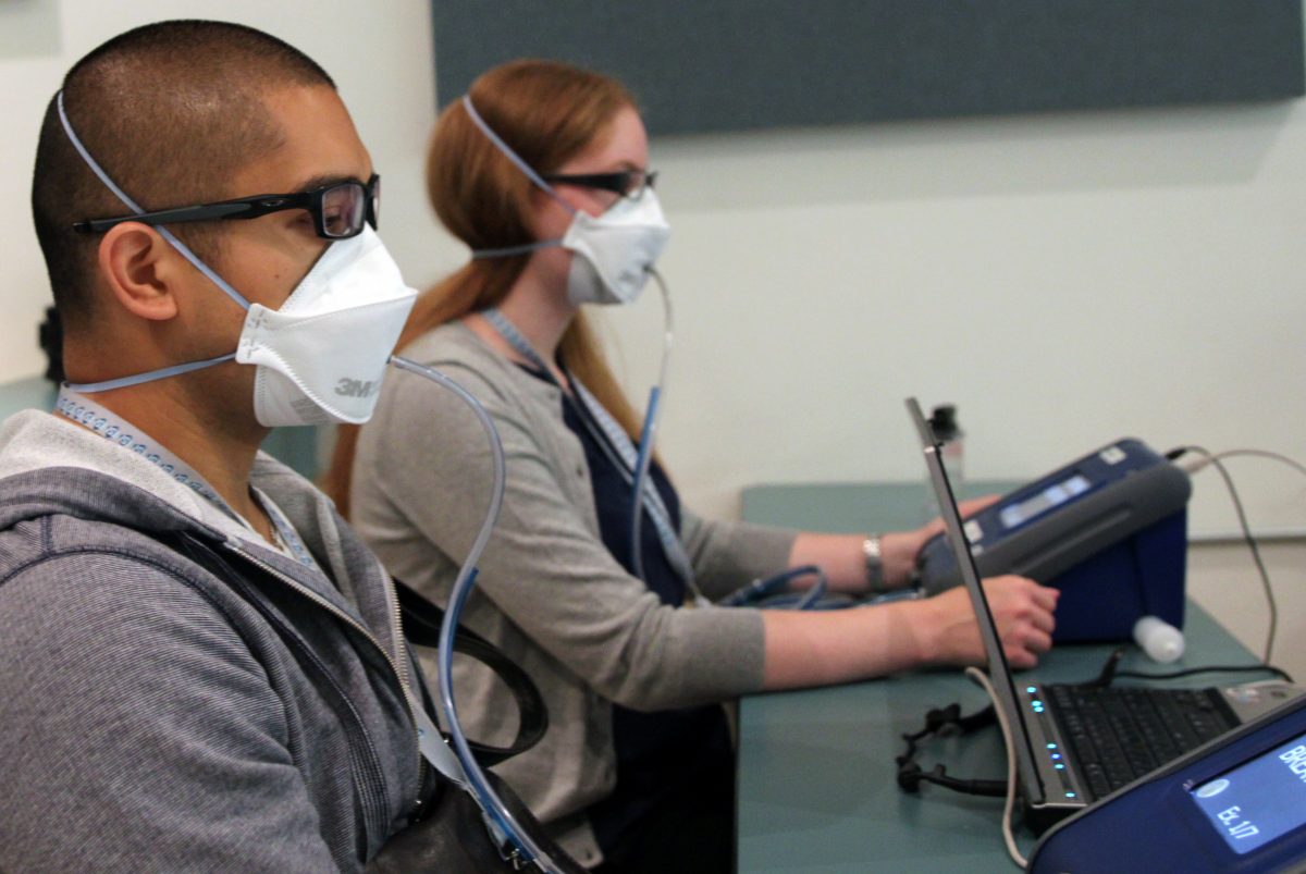 two people being fit tested on quantitative fit test machines