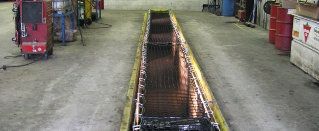 net covering open oil pit in a mechanics shop