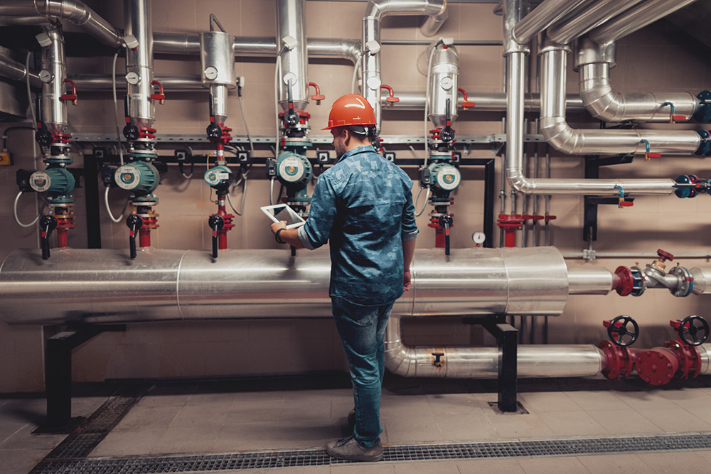 Safety worker standing in front of boilers