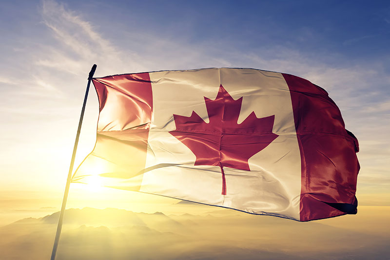 Canada Canadian flag textile cloth fabric waving on the top sunrise mist fog