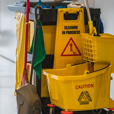 Maintenance cleaning supplies showing a yellow was bucket and mop
