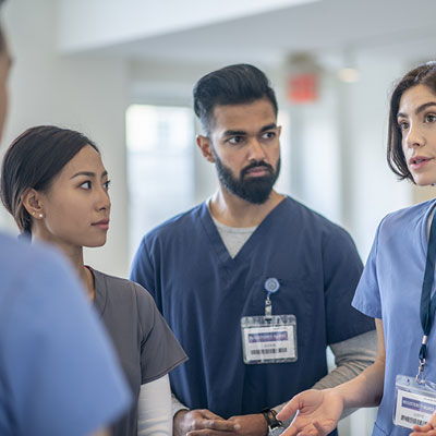 Male and female nurses having a conversation