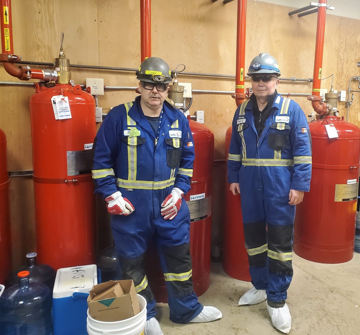 Two Levitt-Safety workers on a service call for gas fire suppression tanks